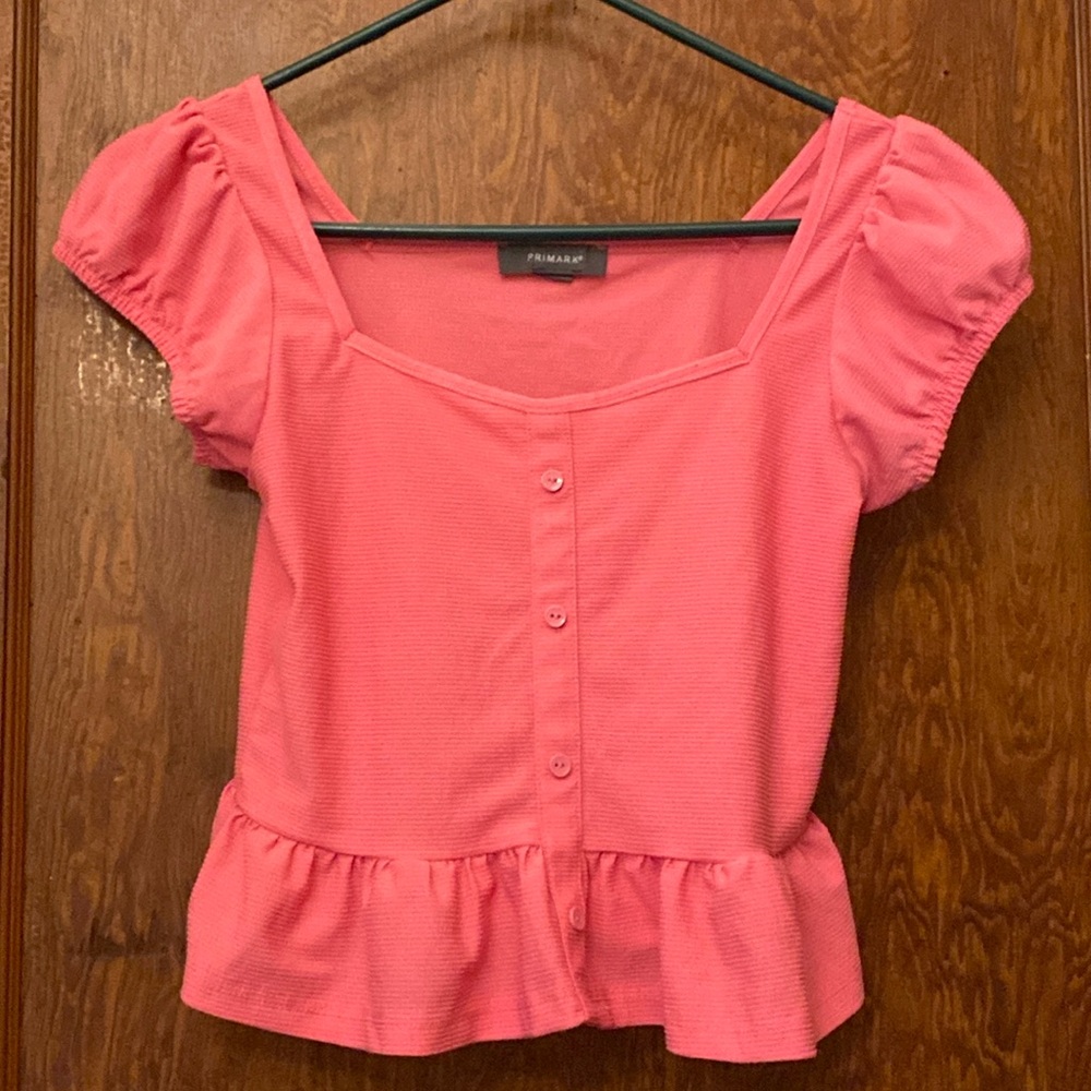 Pink short sleeve shirt with buttons in the front